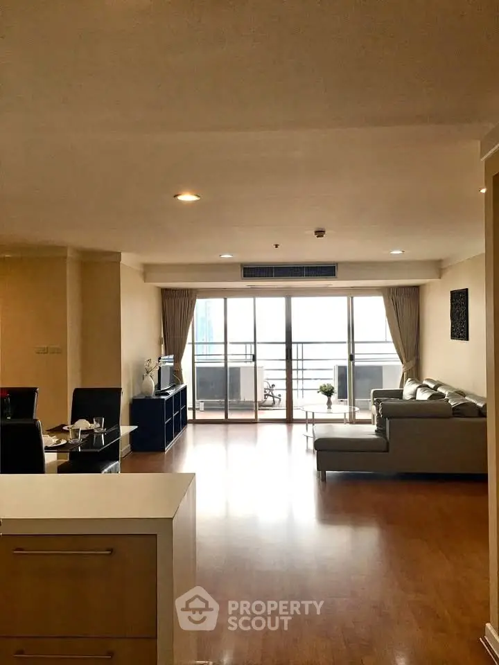 Spacious living room with modern decor and large balcony access.