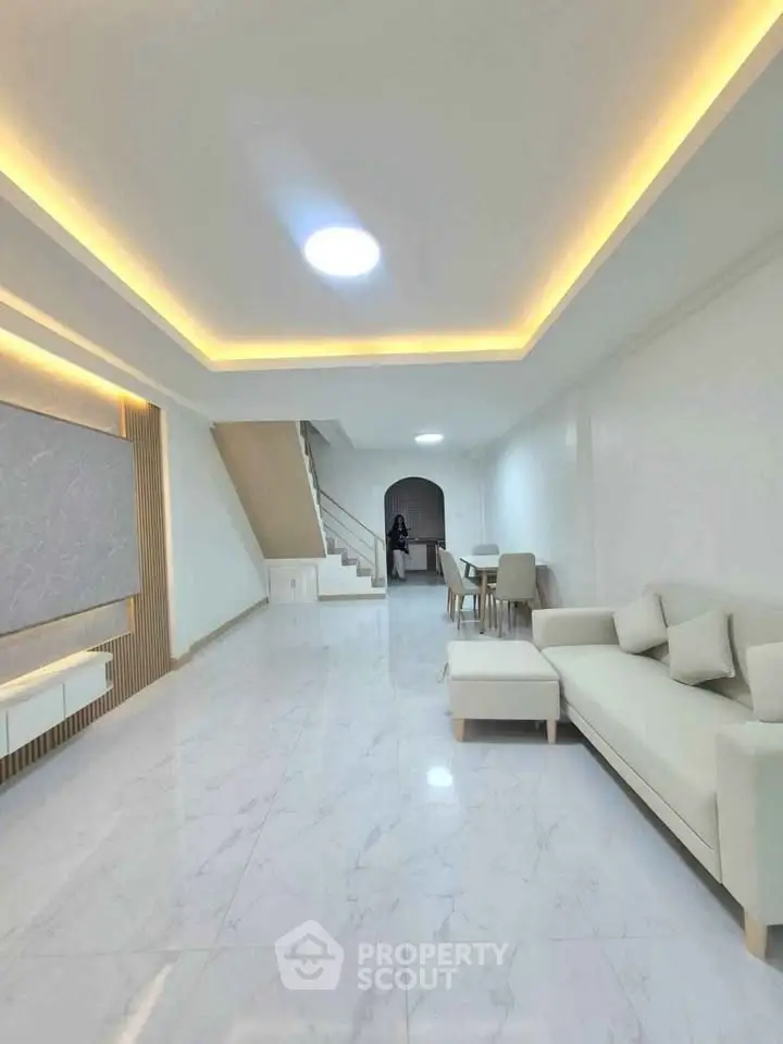 Spacious modern living room with elegant lighting and sleek marble flooring