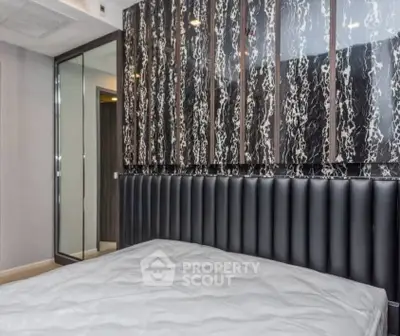 Luxurious bedroom with elegant marble accent wall and plush headboard