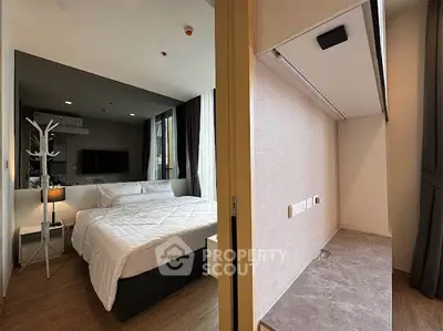 Modern bedroom with cozy bed and stylish decor in a contemporary apartment.