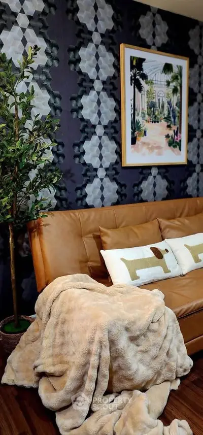 Stylish living room with modern decor, featuring a cozy sofa, decorative wall art, and a lush indoor plant.