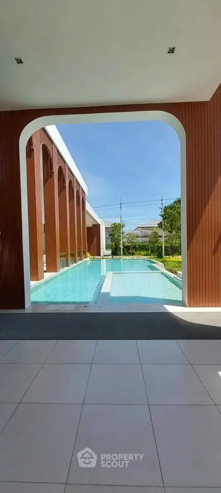 Luxurious poolside view with modern architectural design and serene outdoor ambiance.