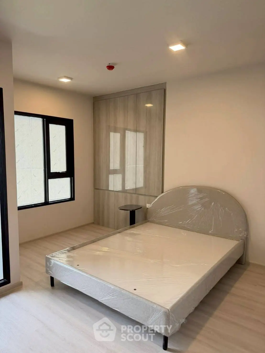 Modern bedroom with minimalist design and large window for natural light