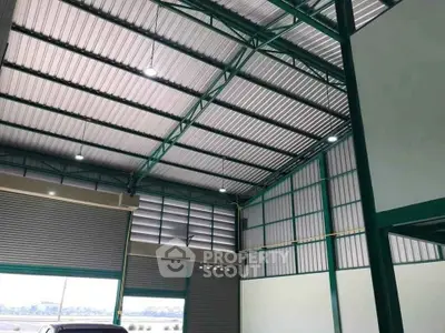 Spacious industrial warehouse with high ceilings and large roller doors