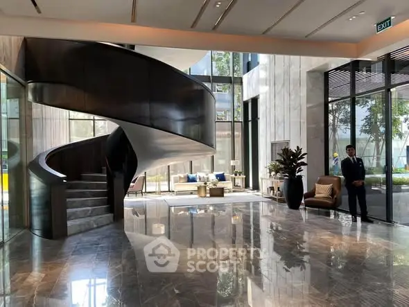 Luxurious building entrance with elegant spiral staircase and modern decor