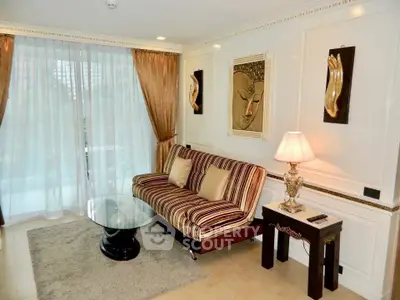 Elegant living room with striped sofa, glass coffee table, and artistic wall decor in a luxurious apartment.