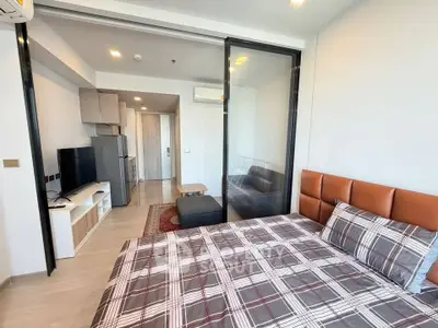 Modern studio apartment with stylish decor and open layout, featuring a cozy bedroom and living area.