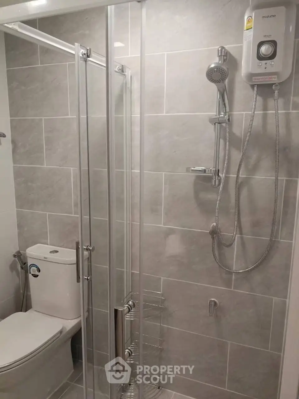 Modern bathroom with glass shower and sleek fixtures in a contemporary home.