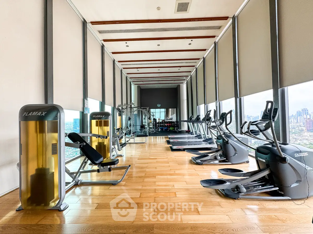 Luxurious high-rise gym with panoramic city views and modern fitness equipment.
