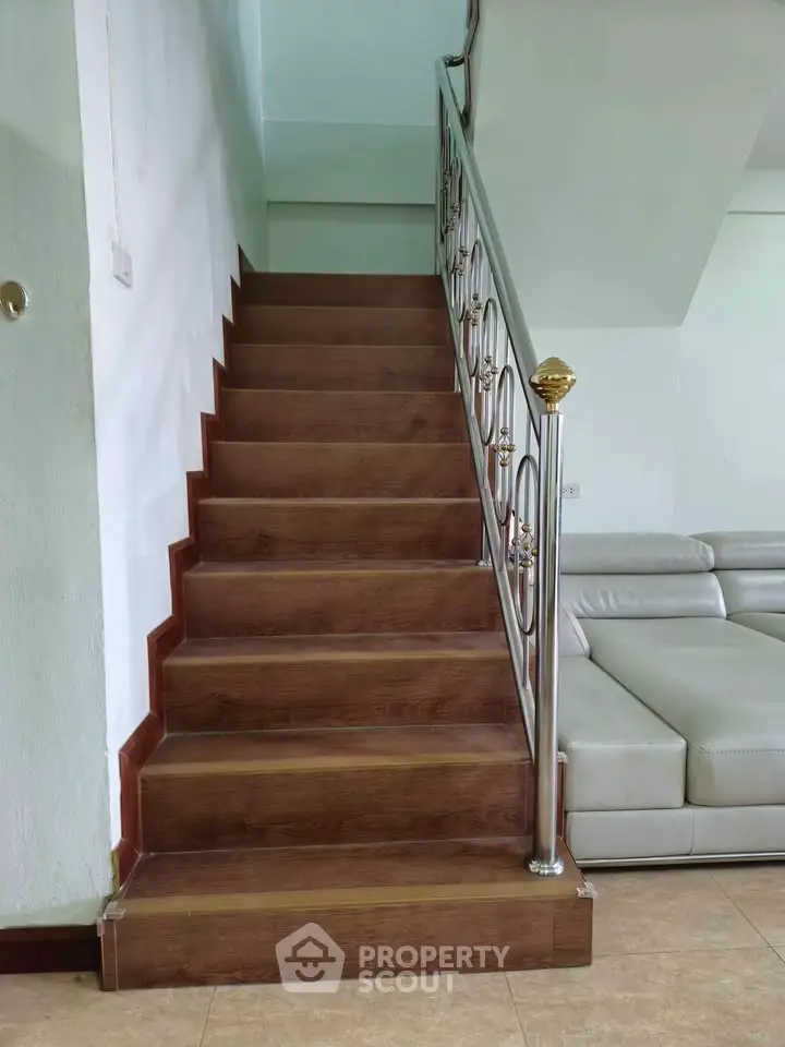 Elegant wooden staircase with modern railing in a stylish living room