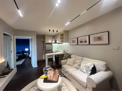 Modern living room with stylish decor and open kitchen layout, perfect for urban living.