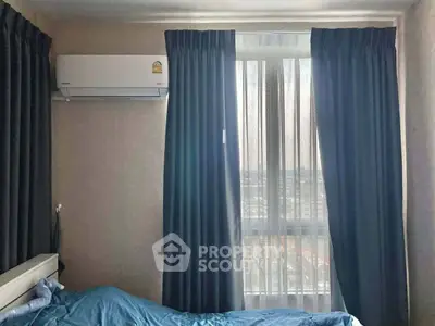 Cozy bedroom with air conditioning and city view through window