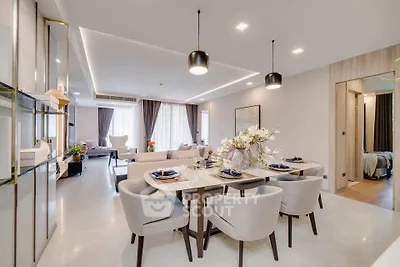 Luxurious open-plan living and dining area with elegant decor and modern lighting.