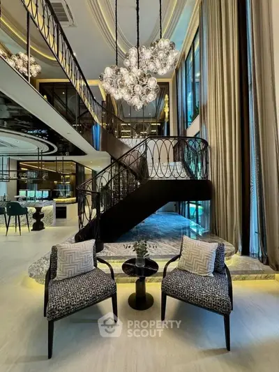 Luxurious modern living room with elegant staircase and chandelier