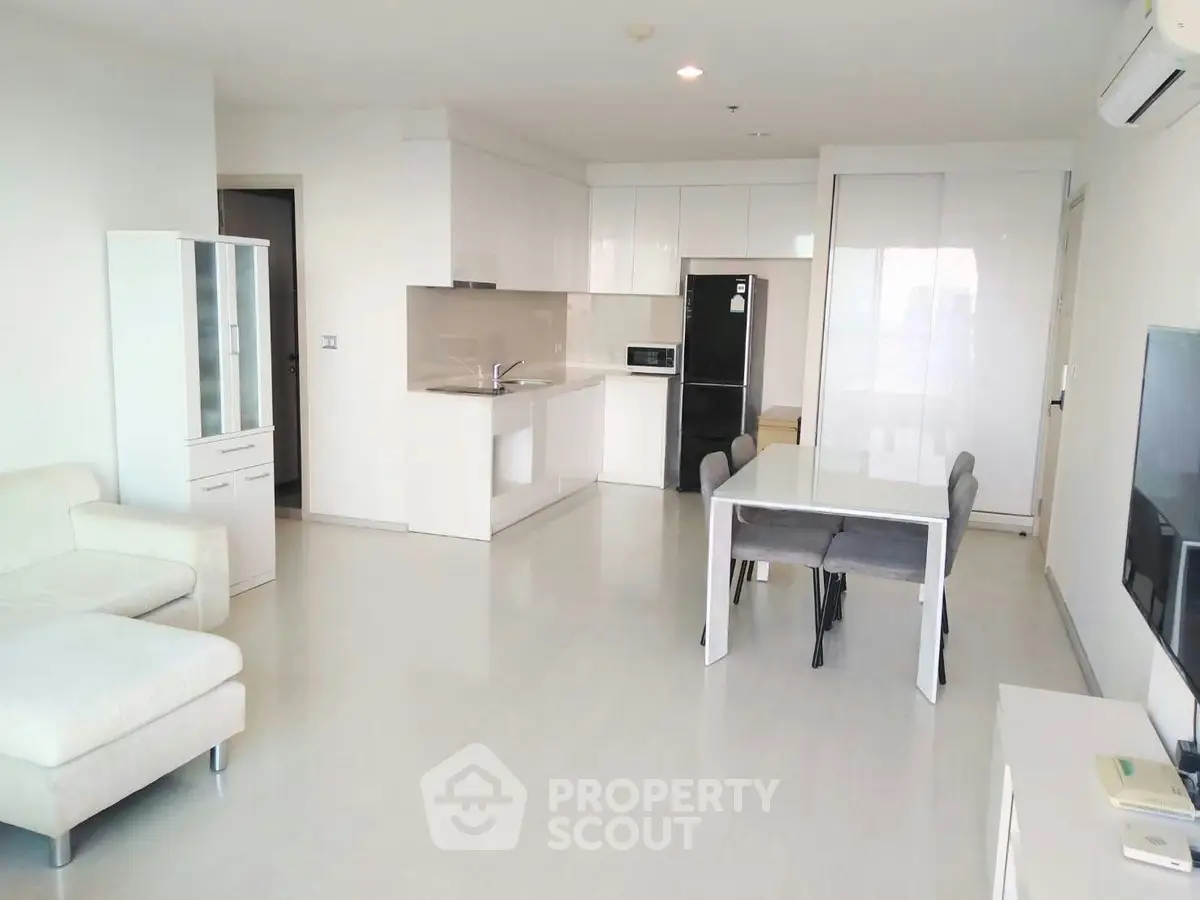 Spacious modern living room with open kitchen in a bright apartment