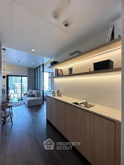 Modern living room with sleek design and city view, featuring stylish furniture and open layout.