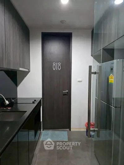 Modern kitchen with sleek dark cabinetry and stainless steel appliances