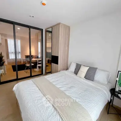 Modern bedroom with mirrored closet and cozy decor in stylish apartment