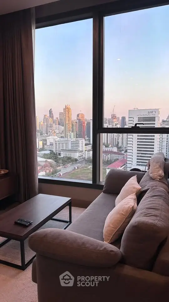 Luxurious living room with stunning city skyline view from high-rise apartment window.