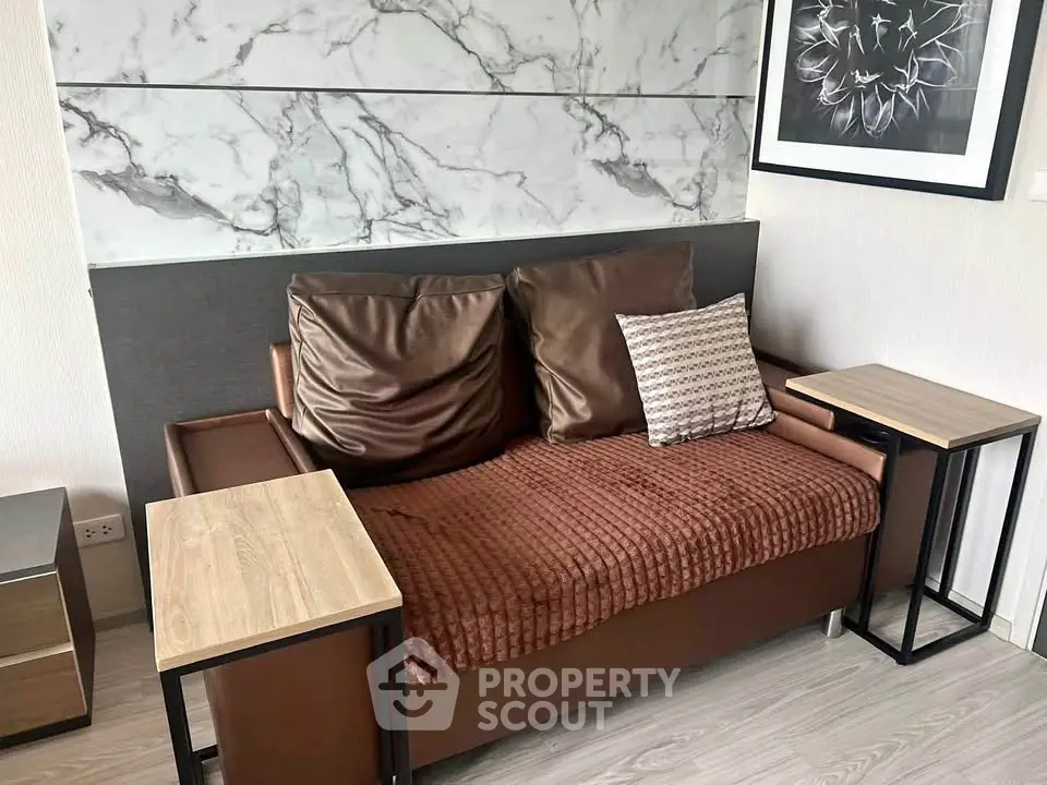 Modern living room with stylish sofa and marble accent wall