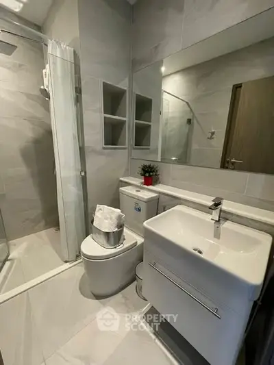 Modern bathroom with sleek fixtures and glass shower enclosure