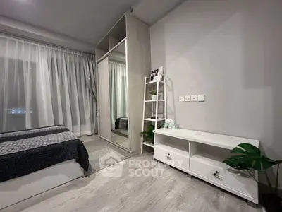 Modern bedroom with sleek wardrobe and stylish decor, perfect for urban living.