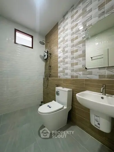 Modern bathroom with stylish tiles and sleek fixtures in a contemporary home.