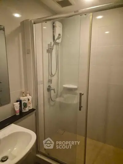 Modern bathroom with glass shower enclosure and sleek fixtures