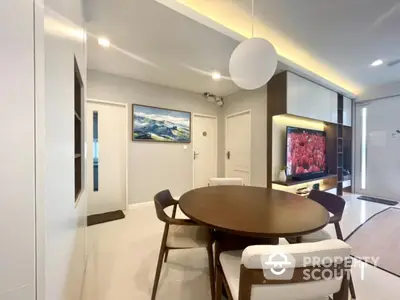 Modern dining area with stylish round table and elegant lighting