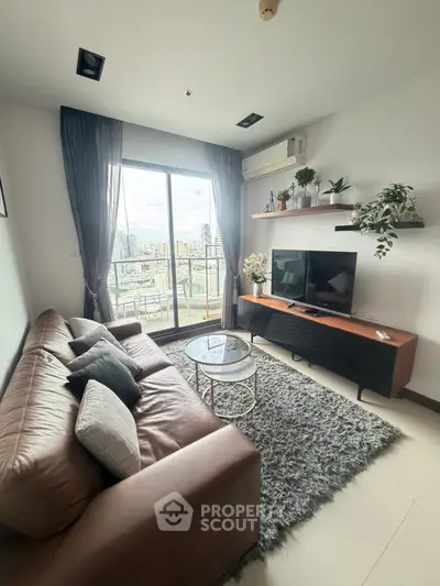 Modern living room with leather sofa, TV, and balcony view in high-rise apartment.