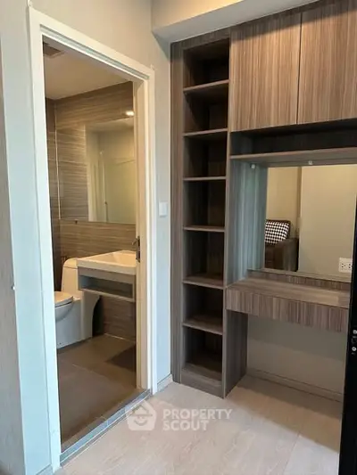 Modern bathroom with sleek wooden shelving and vanity area