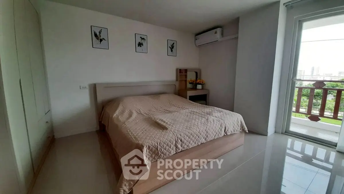 Spacious bedroom with modern decor and balcony view