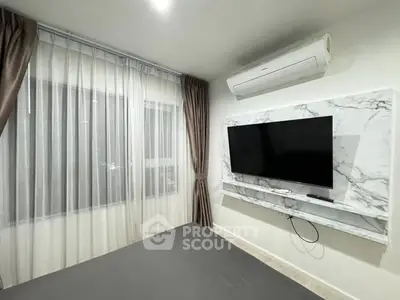 Modern bedroom with wall-mounted TV and air conditioning