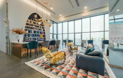 Luxurious modern living room with floor-to-ceiling windows and stylish decor in high-rise apartment.