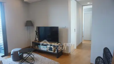 Modern living room with sleek TV setup and stylish decor in a contemporary apartment.