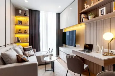 Modern living room with stylish decor and built-in shelves, featuring a cozy seating area and a wall-mounted TV.