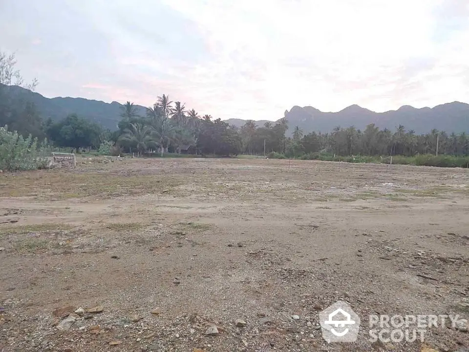 Expansive land plot with scenic mountain views and lush greenery, ideal for development or investment.