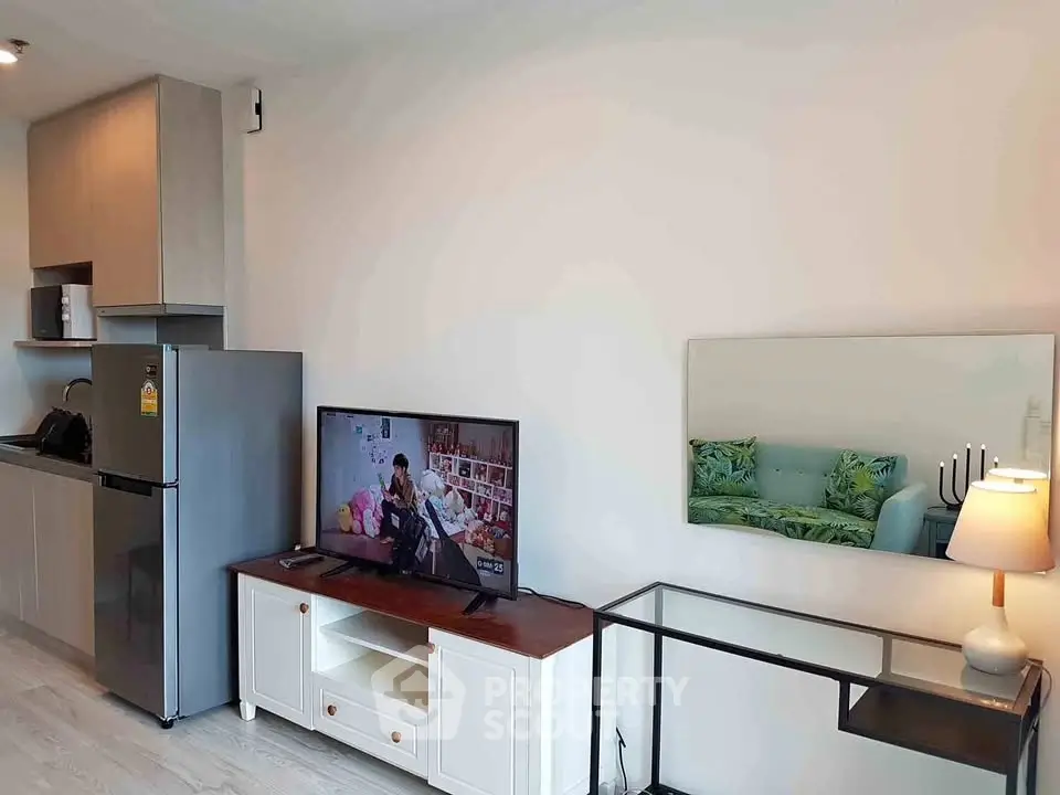 Modern living room with sleek kitchen, stylish decor, and cozy ambiance