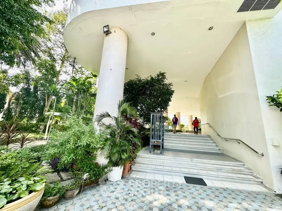 Elegant building entrance with lush greenery and modern design