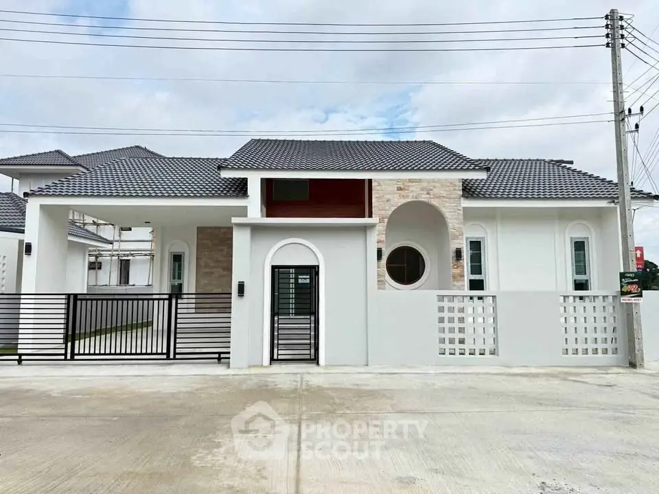 Modern single-story house with stylish facade and gated entrance in a serene neighborhood.