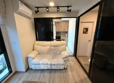 Modern living room with cozy white sofa and stylish decor in a contemporary apartment.