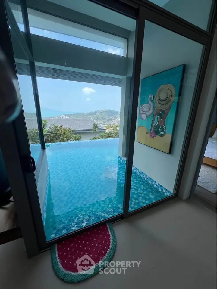 Luxurious infinity pool with stunning mountain and lake view from modern home.