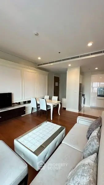Spacious modern living room with elegant dining area and open kitchen layout.