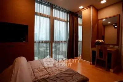 Luxurious bedroom with floor-to-ceiling windows and stunning city view