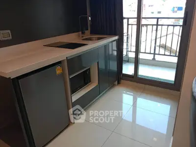 Modern kitchen with sleek appliances and balcony access