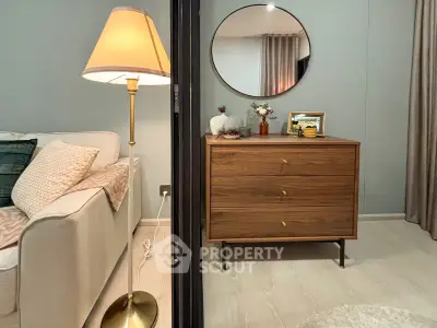 Stylish living room with elegant decor and modern furniture, featuring a cozy sofa and chic lamp.