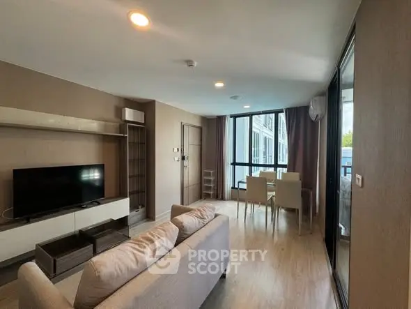 Spacious modern living room with large windows and stylish furniture