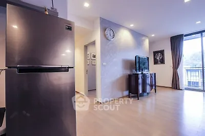 Modern living room with sleek fridge and balcony view