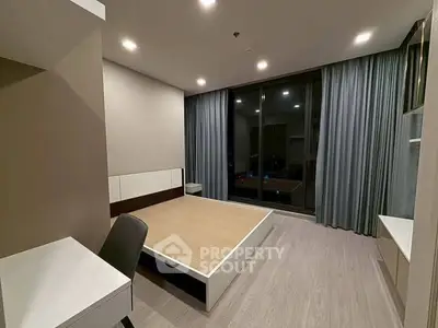 Modern bedroom with large windows and minimalist design in a stylish apartment.