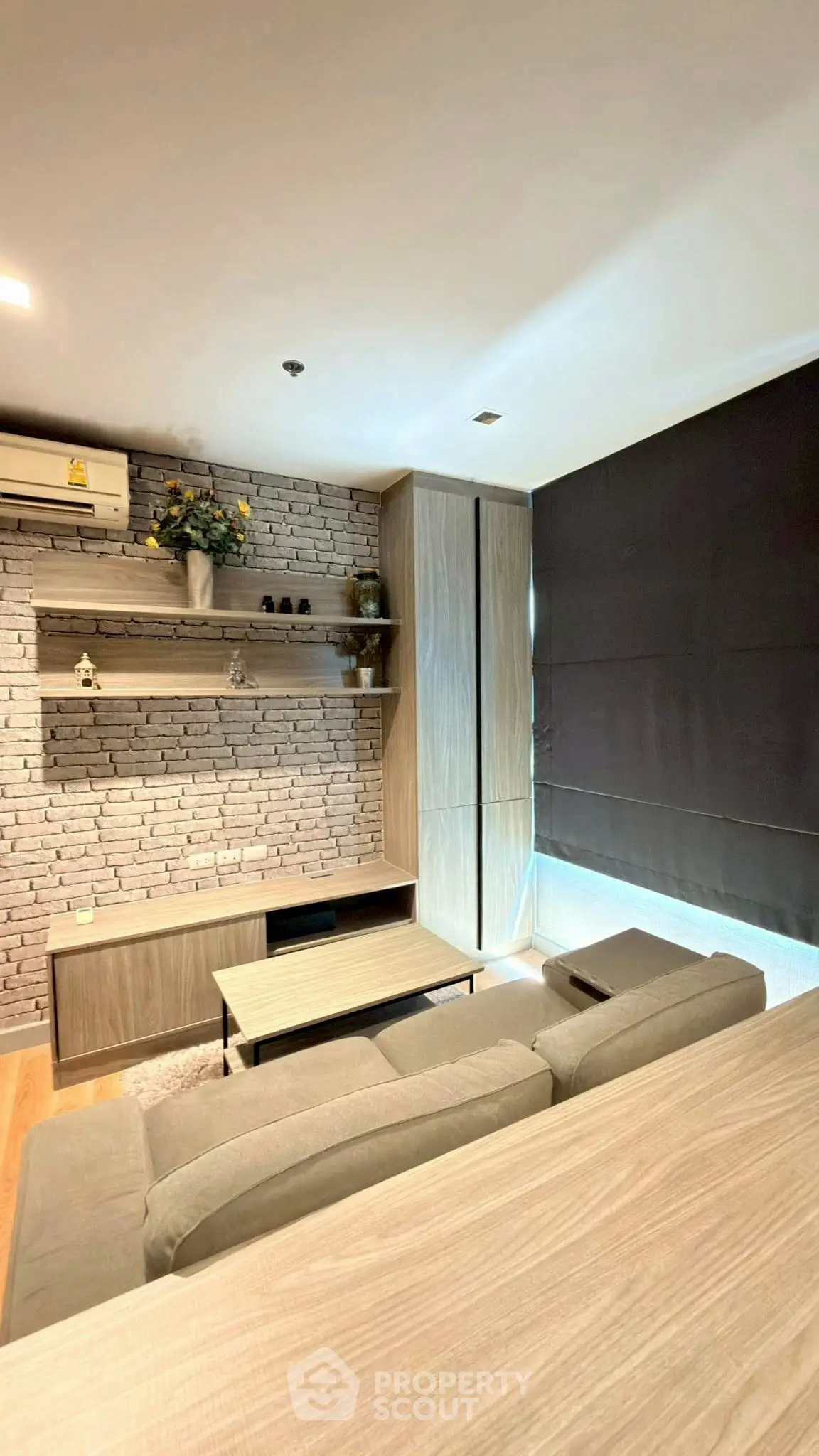 Modern living room with stylish brick wall and cozy furniture